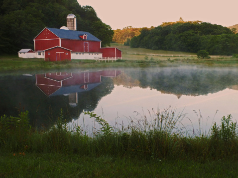 American Farmhouse reflected in a pond
