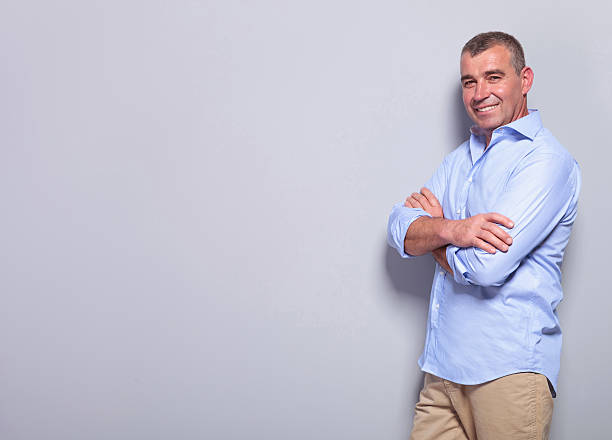 istock casual old man with arms crossed on gray 453455247