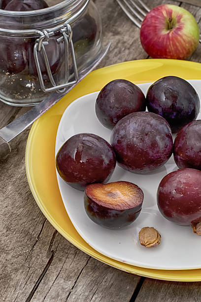 istock plums on a wooden background 453455461