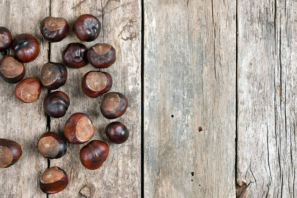 istock Closeup chestnuts on wooden desk 453461413