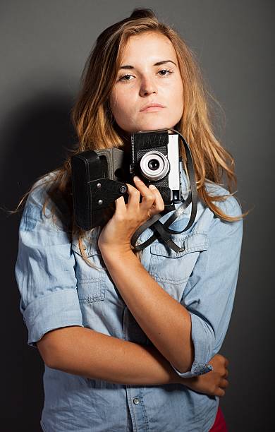 istock Sexy photographer woman with old camera 453461475
