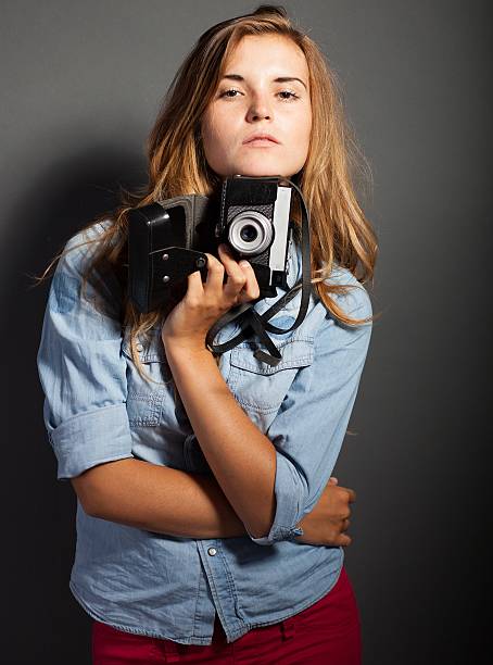 istock Thinking photographer woman with old camera 453461671