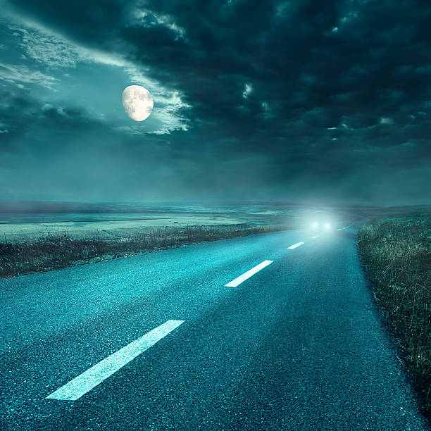 istock Driving on asphalt road at night towards the headlights 453462183