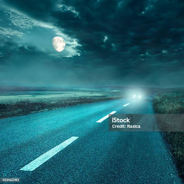 Driving On Asphalt Road At Night Towards The Headlights Stock Photo - Download Image Now
