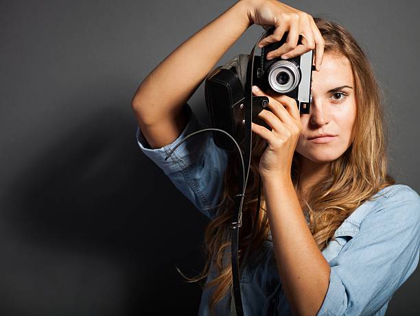 istock Young photographer in jeans jacket with old camera 453462379