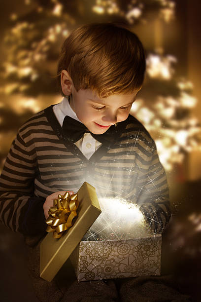 istock Child opening birthday present box. Magic shining gift. 453463095