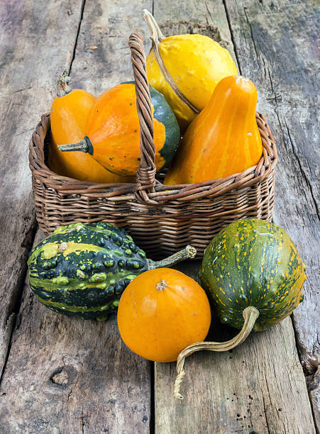 istock Pumpkins on a wooden table and basket 453467223