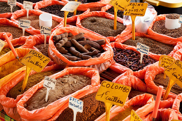 Various spices are displayed in open sacks at a market in Nyons, France