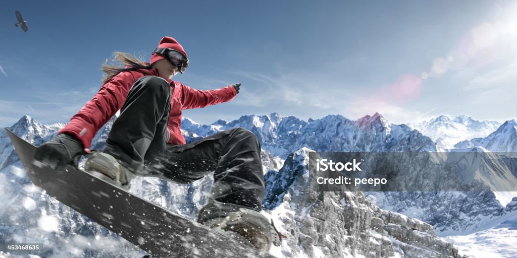 Extreme Snowboarding Girl Close up image of female snowboarder making jump in snowy mountains Snowboarding Stock Photo