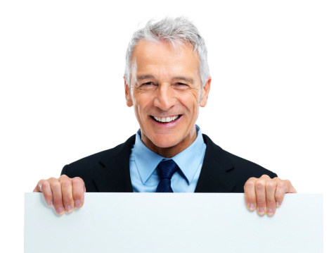 Smiling business man holding a white board