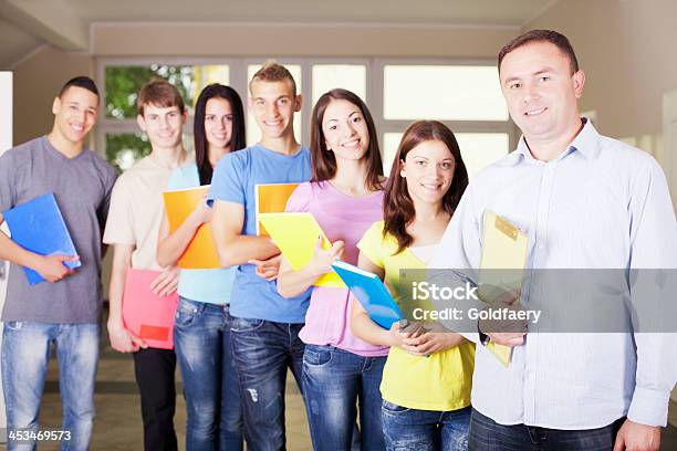 Teacher Is Standing In School Hall With Students Stock Photo - Download Image Now - School Principal, Student, Adolescence