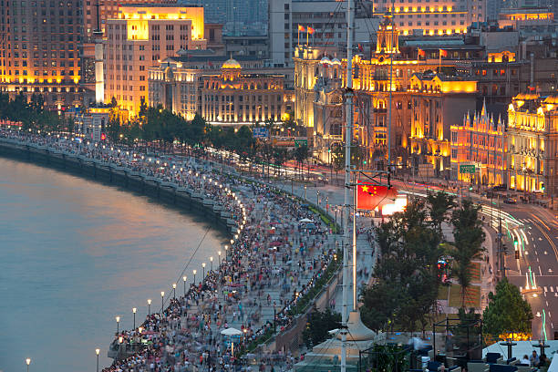 Night shot of the famous Bund in Shanghai, China. Crowds of people gather here at sunset to view the Shanghai Skyline with its famous Oriental Pearl Tower. Nikon D3X. Converted from RAW.