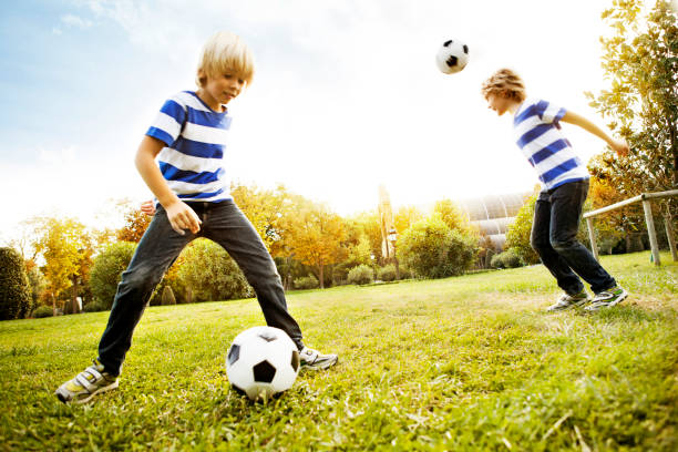 istock Composite of boy playing with soccer ball 453469671