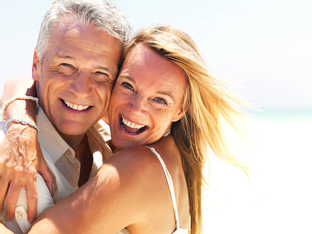 istock Cheerful mature couple together at the beach 453469771