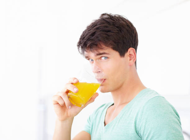 istock Enjoying some fresh orange juice 453470567