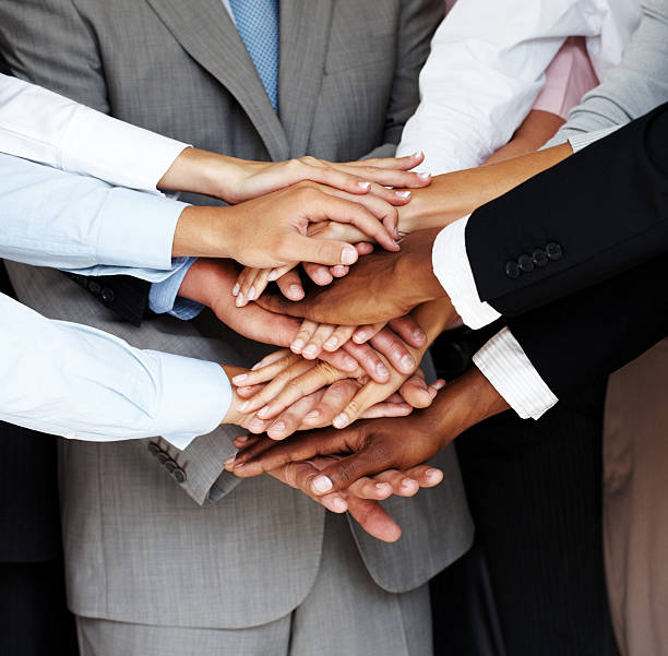 istock Symbol of unity and teamwork - Hands piled on top 453471629
