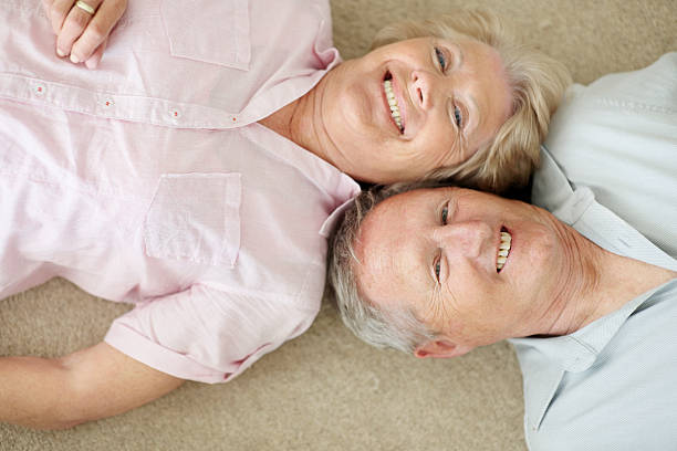 istock Mature couple lying down with their heads together 453471969