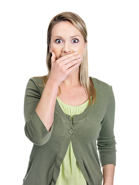 istock Surprised - Young female with hand over mouth against white 453471989