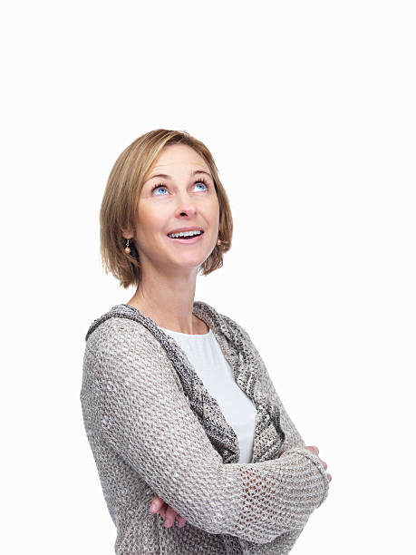 istock Pretty middle aged woman looking up over white background 453472513