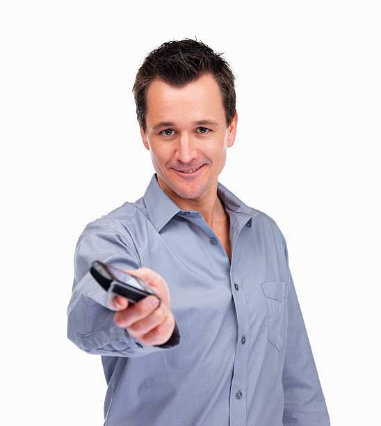 istock Happy mature guy holding a new cell phone on white 453473049