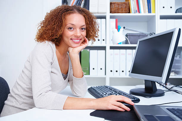 istock Smiling young woman working in office 453473713