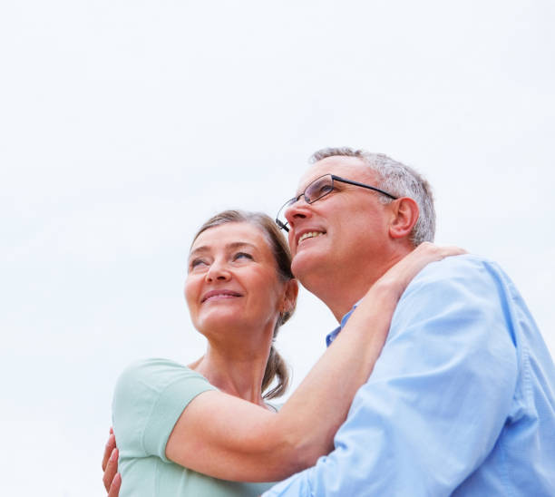 istock Cute mature couple hugging eachother against white background 453474185