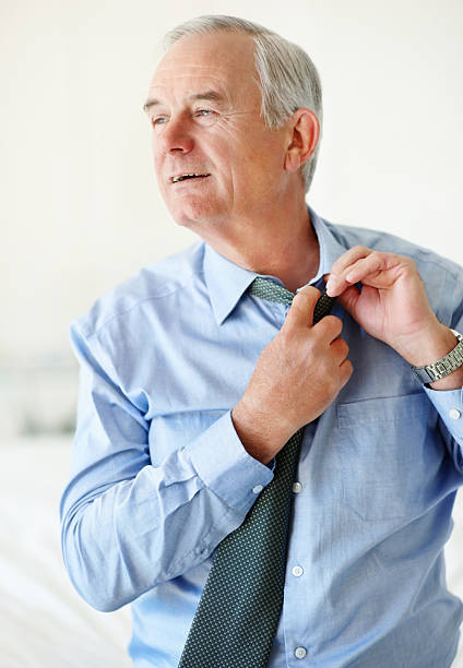 istock Happy senior business man taking off his tie 453477203