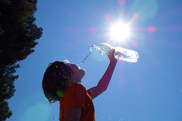 Hot. Child pouring water on himself. Heat stock pictures, royalty-free photos & images