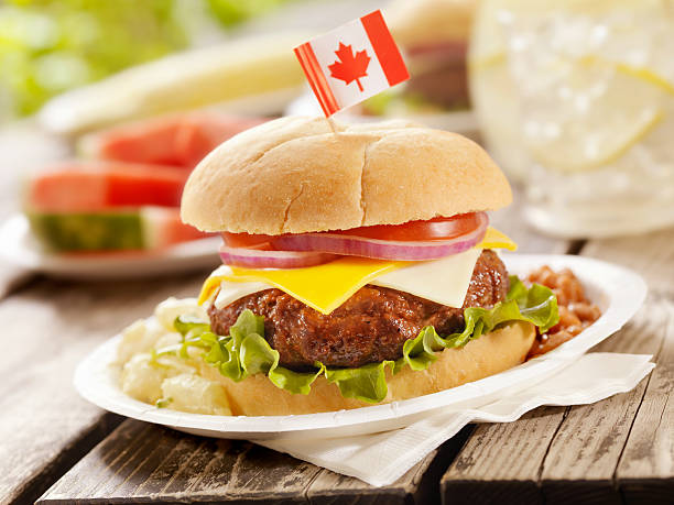 BBQ Cheeseburger with Lettuce,Tomato and Red Onion with Potato Salad and Baked Beans at a Canada Day Picnic -Photographed on Hasselblad H3D2-39mb Camera