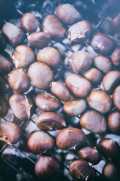 istock Chestnuts roasting on outdoor grill over charcoal fire in winter 453480169