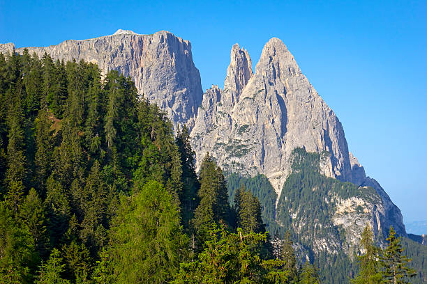 Schlern Massif, Santner Spitze. Italian Siciliar. Santner Spitze is a peak at the north west end of the Schlern mountain massif in the Dolomites (South Tyrol, Italy). The Dolomites are part of Southern Limestone Alps in Europe. In August 2009, the Dolomites were declared a UNESCO World Heritage Site.