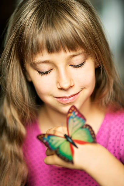 istock Little girl and butterfly 453481649