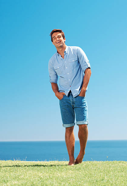 istock Smiling young man standing in park 453484445