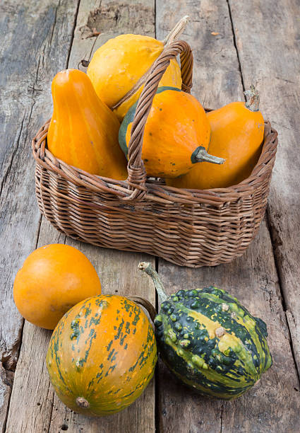 istock Pumpkins on a wooden table and basket 453486463
