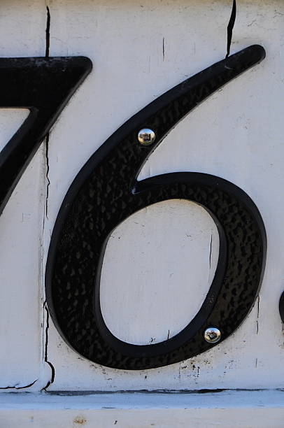 Street metal address black number 6 on white  with screws stock photo