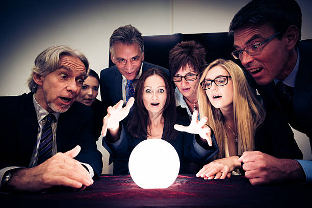 business team using a crystal ball to look into future stock photo