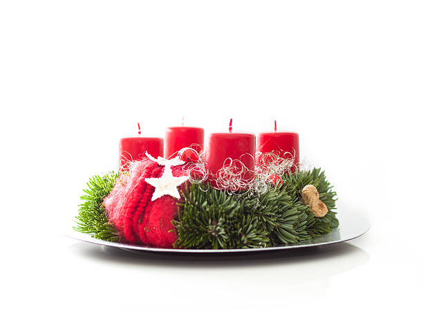 Advent wreath with fir branches on plate - Adventskranz Advent wreath with fir branches on plate with white background advent candle wreath adventskranz stock pictures, royalty-free photos & images