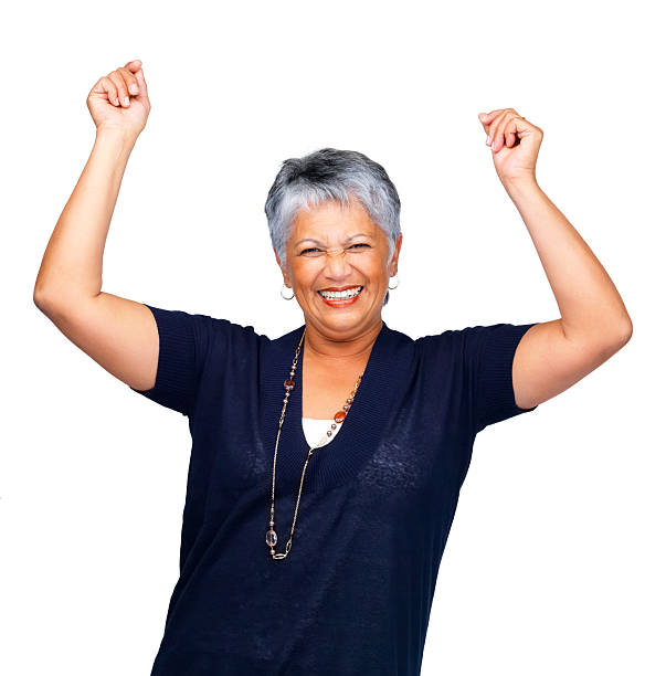 istock Senior woman smiling over white with hands raised 453490813