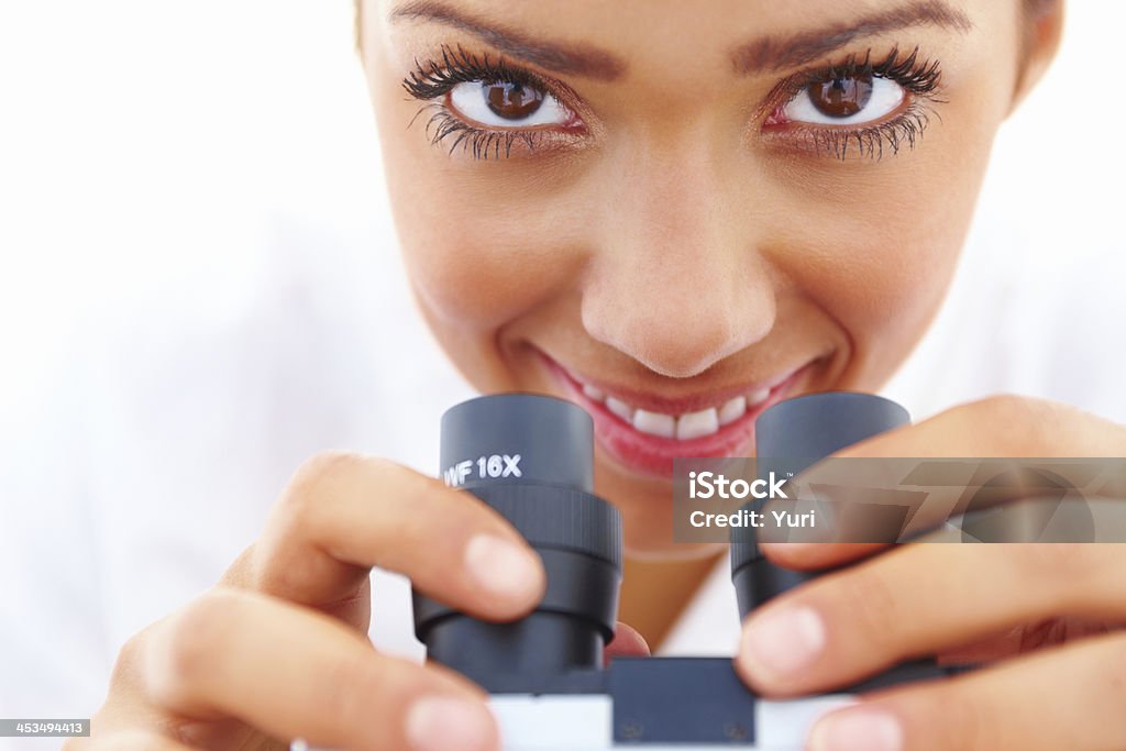 Closeup portrait of a happy girl holding a microscope Built Structure Stock Photo