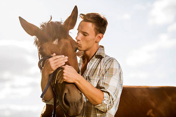 istock Young man kissing his horse. 453494835