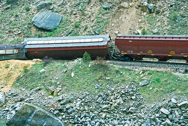 Spilled grain from train derailed by landslide in Wyoming Grain spilled on riverbank from train derailed by landslide in hard rain in central Wyoming derail stock pictures, royalty-free photos & images