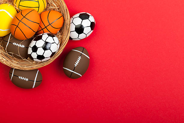 Easter Eggs on Red Eater eggs painted as sport balls isolated on red tennis ball container stock pictures, royalty-free photos & images