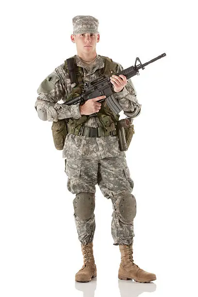 Photo of Portrait of an army man standing with a rifle