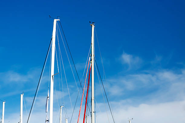 istock Group of mast against blue sky with clouds, copy space 453505507