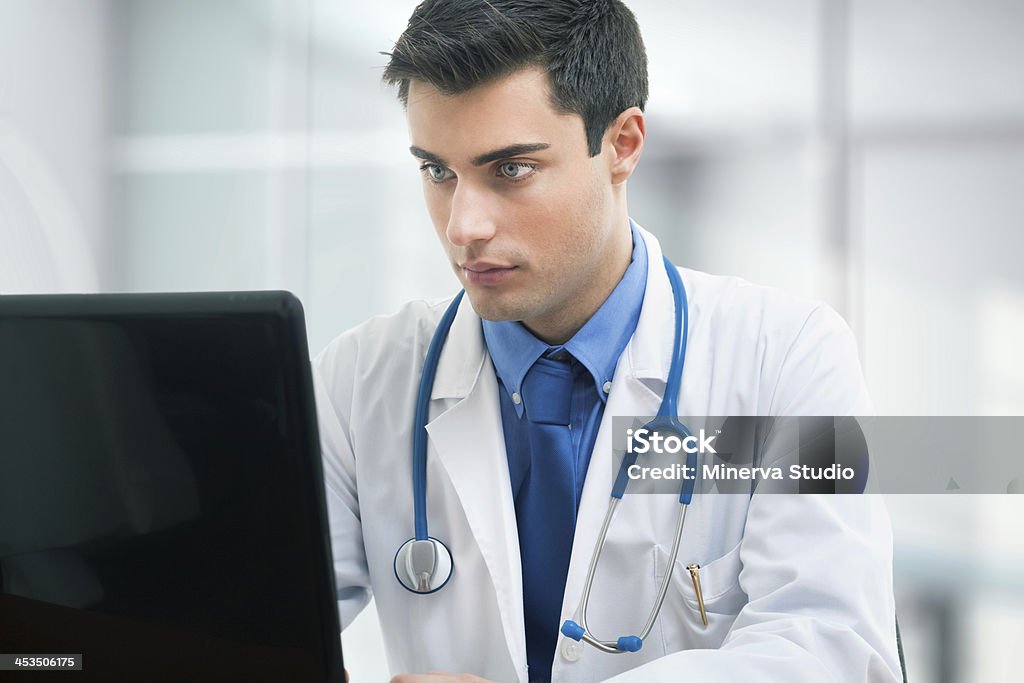 Médico usando una computadora portátil en la habitación - Foto de stock de Asistencia sanitaria y medicina libre de derechos
