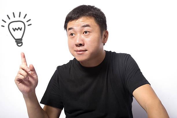 Business Idea Concept Asian man with idea lightbulb on white background man with a light bulb over his head stock pictures, royalty-free photos & images
