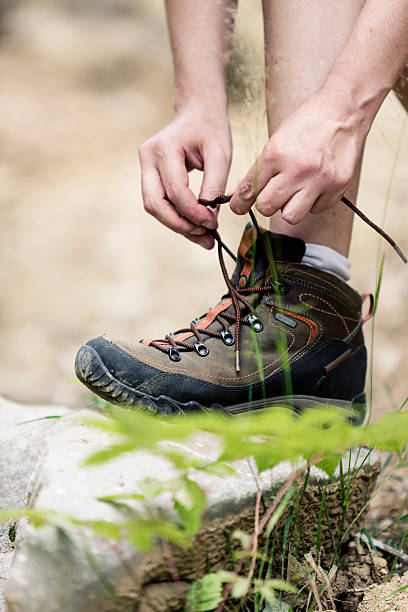 istock Female hiker tying boot laces 453507837