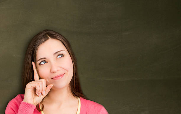 istock Woman in front of empty blackboard. 453510949