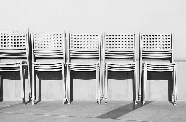 istock Row of chairs on white wall 453512357