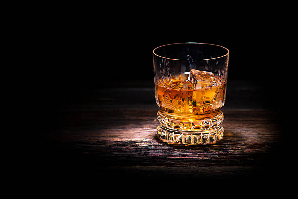 istock A glass of whiskey with ice on the table 453512445